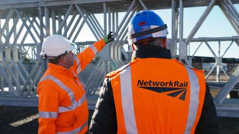 A Network Rail engineer (left) talks to a Ukrainian engineer at Mabey Bridge HQ engineering firm in Gloucester