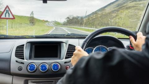 Hands on a steering wheel