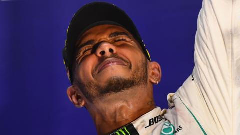 Lewis Hamilton celebrates on the podium