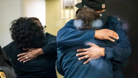 People embrace after shootings at the FedEx facility in Indianapolis, Indiana,