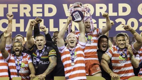 Wigan captain Liam Farrell lifts the World Club Challenge trophy