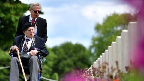 British army veteran Cedric Wasser looks at the graves of fallen soldiers