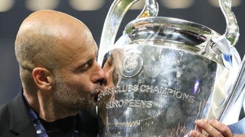 Pep Guardiola kisses the Champions League trophy