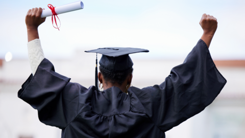 A young woman cheering on graduation day - generic shot