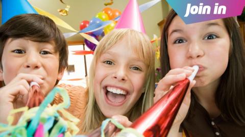 Three kids blowing noise makers at birthday party.