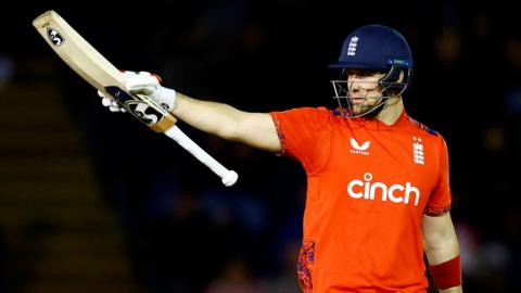 England batter Liam Livingstone raises his bat after hitting fifty