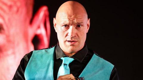 Tyson Fury in a blue vest and tie