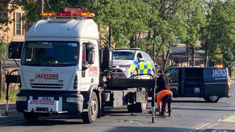 A recovery truck with a police car on the back of it in Carlton Road, Nottingham
