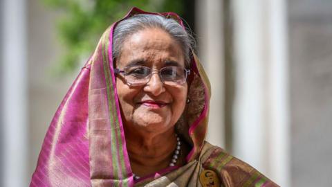 Sheikh Hasina wearing a pink veil against a white background