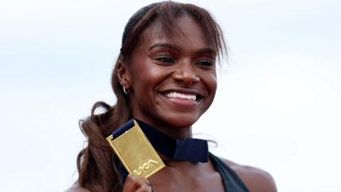 Dina Asher-Smith poses with her 200m gold medal at the UK Athletics Championships