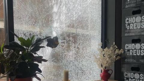 One of the smashed windows at Flat Earth Pizzas