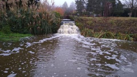 Moat at Bishop's Palace with brown looking water