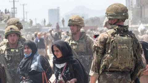 Members of the British and US military engaged in the evacuation of people out of Kabul, Afghanistan