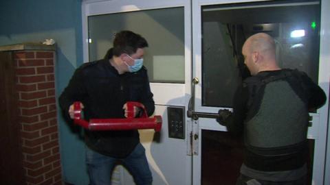 Immigration Enforcement officials raiding a flat in north-west London