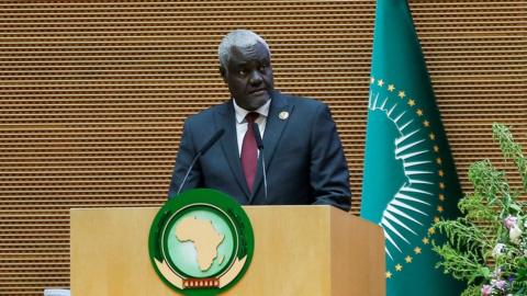 Chair of African Union Commission Moussa Faki Mahamat standing at a podium
