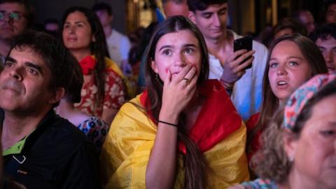 A supporter of Partido Popular (Popular Party) reacts as she follows the electoral count of the Spanish General Elections at the Partido Popular headquarters in Madri