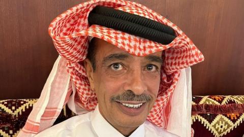 Naji Rashed Al Naimi, a Qatari man, is pictured sitting on a sofa and wearing a traditional kaffiyeh headdress