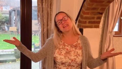 Estate agent Claire Cossey singing in a house