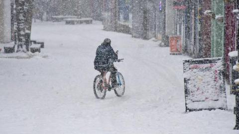 Cyclist in the snow in Oswestry, Shropshire, on Thursday