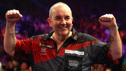 Phil 'The Power' Taylor celebrates after winning at the Circus Tavern