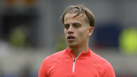 Cameron Peupion on the pitch pre-match for Brighton