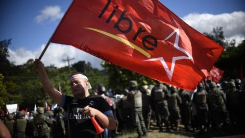 A supporter of opposition candidate Salvador Nasralla takes part in a march on December 3, 2017 in