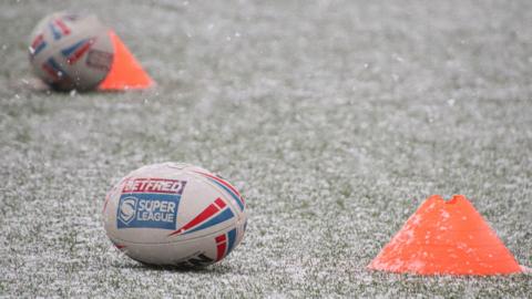 Leeds Rhinos training shot of balls in the snow