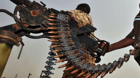 A Sudanese soldier poses with a machine gun in the oil town of Heglig bordering with South Sudan on April 24, 2012