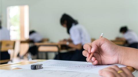 Hand holding pencil