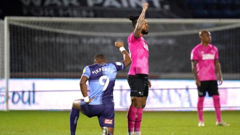 Derby striker Colin Kazim-Richards opted for a raised fist to a bended knee before the game with Wycombe in February