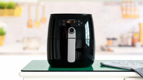 An air fryer on a kitchen worktop.