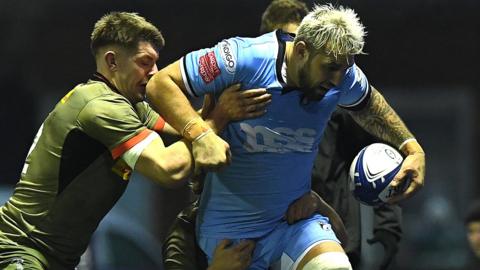 Josh Turnbull of Cardiff is tackled by Luke Northmore