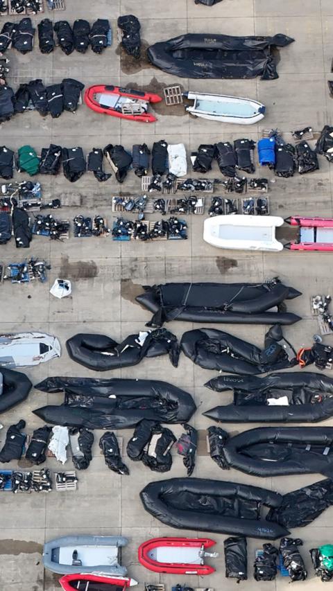 An aerial view of small boats on land.