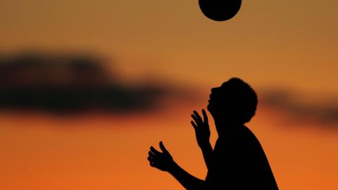 silhouette of player heading ball