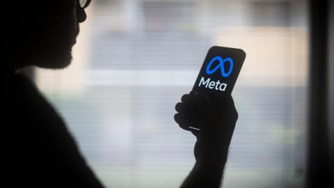 A stock image of meta logo on a phone