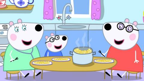 Penny Polar Bear and her two mothers sit around a table eating dinner