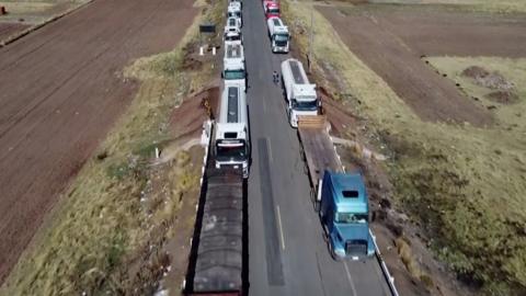 Trucks at a standstill at a border between Peru and Bolivia