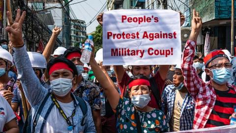 People make three-finger salutes during an anti-coup march in Yangon, Myanmar