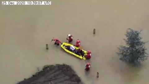 Nine people and three dogs are rescued from floods in Harrold, Bedfordshire
