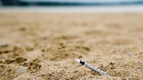 A syringe at a beach