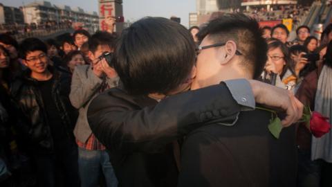 In a picture taken on 8 March 2011 a gay couple kiss during their ceremonial 'wedding' as they try to raise awareness of the issue of homosexual marriage, in Wuhan, in central China's Hubei province.