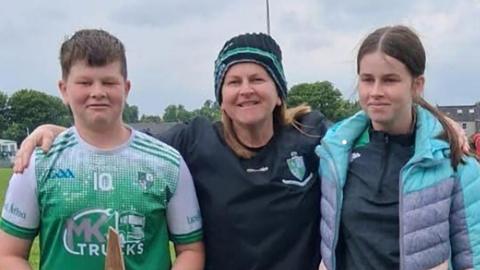 Vanessa Whyte, centre standing with her arms around her son and daughter, James and Sara. 