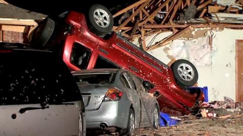 A car overturned amid tornado damage