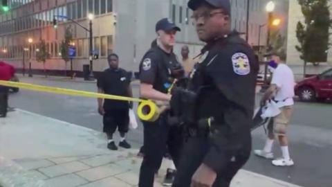 Police are shown in social media clips from the scene of the shooting