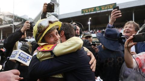 Jockey Flavien Prat celebrates with the connections of Country House after winning the Kentucky Derby