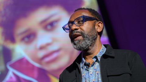 Sir Lenny Henry in front of an image of Cole Martin at a screening of My Name Is Leon