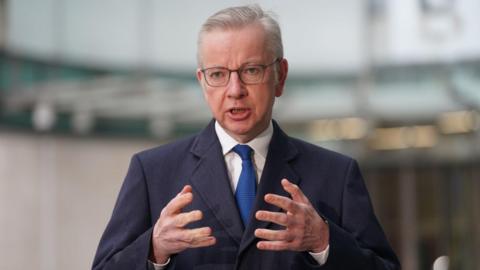 Michael Gove stood outside BBC building in London