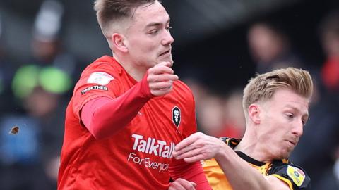 ayden Lindley of Newport County and Luke Bolton of Salford City