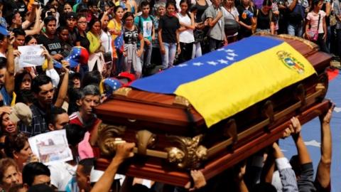 Mourners carry the coffin of Neomar Lander, who died during a protest against Venezuelan President Nicolas Maduro's government, during his funeral in Guarenas, Venezuela June 9, 2017