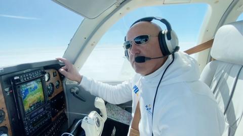 Pilot inside the cockpit of a plane mid-flight